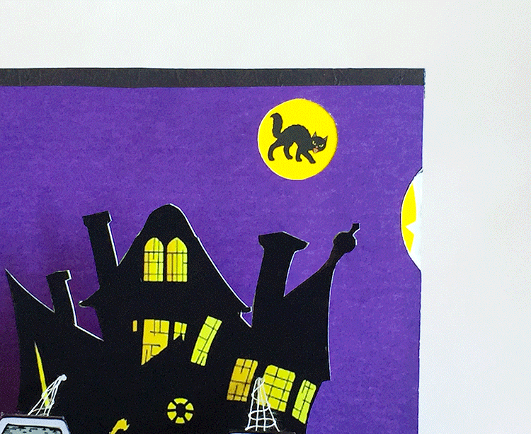 Rotating wheel shows Halloween creatures flying in front of yellow moon